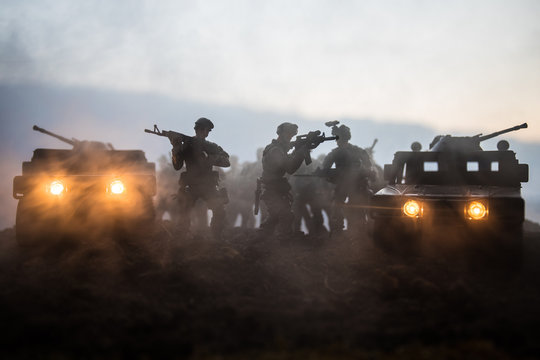 Military patrol car on sunset background. Army war concept. Silhouette of armored vehicle with gun in action. Decorated. Selective focus