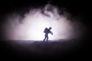 Military soldier silhouette with gun. War Concept. Military silhouettes fighting scene on war fog...