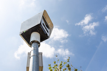 Close-up on speed trap surveillance camera along highway.