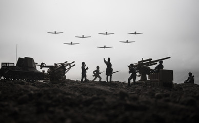 An anti-aircraft cannon and Military silhouettes fighting scene on war fog sky background. Allied...