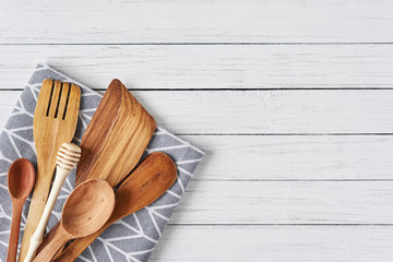 Kitchen utensils, spatula and towel on a white wooden background with copy space