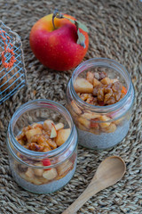 Healthy Vegan Chia Pudding in a glass with Almond Milk, Baked Apple and Walnuts