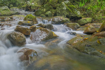Krok E-Dok Waterfalls, beautiful silky water flowing around with green trees and arch rocks, Krok...