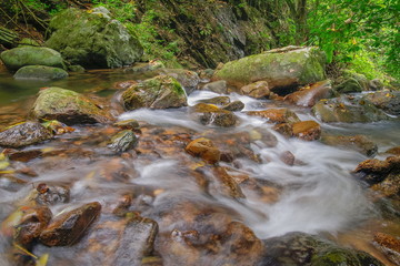 Krok E-Dok Waterfalls, beautiful silky water flowing around with green trees and arch rocks, Krok...