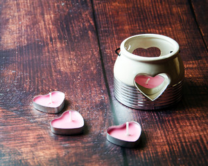 candle in the shape of a heart in a candlestick as the birth of love