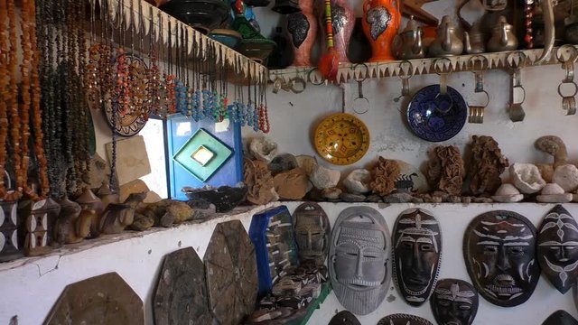 Part of display of local craftsmen handmade souvenirs for tourists in Morocco, Africa - beads, masks, bracelets and mineral stones