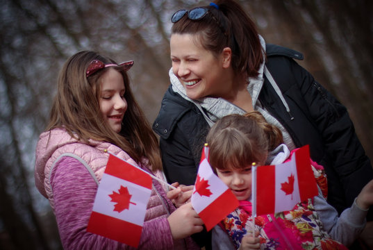 Happy Family With Flag Of Canada