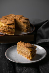 a homemade dessert, slice of cake, on a dark wooden backdrop, dark grey background