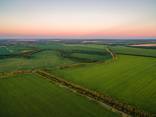 Obraz premium Aerial drone view, at sunset on the river among the fields. The middle band of Russia