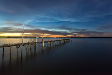 Fototapeta na wymiar Bamboo bridge in the sea the twilight