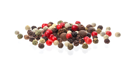 Heap of black, red, white peppercorn seeds isolated on white background