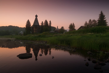 Fototapeta na wymiar Old wooden church at sunset. Karelia, Russian North, Russia.
