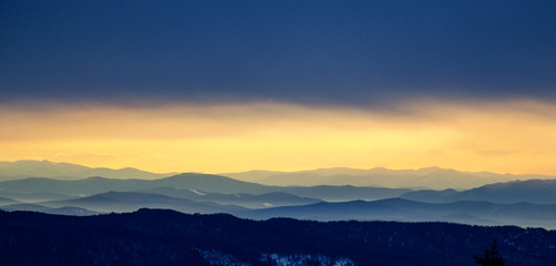 Fototapeta na wymiar Panorama of mountain peaks in Sheregesh at dawn from Mount Zelenaya.