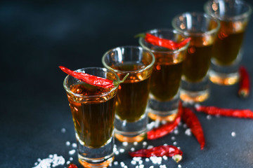 five glasses of alcohol and salt  and red chili, a party at the bar, a menu for the bar. Selective focus and copy space, Tequila shots, vodka,whisky, rum