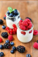 diet breakfast or lunch : organic yogurt with fresh berries of blackberries, raspberries, blueberries, red currants. the concept of a healthy lifestyle, diet food. selective focus and copy space