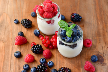 diet breakfast or lunch : organic yogurt with fresh berries of blackberries, raspberries, blueberries, red currants. the concept of a healthy lifestyle, diet food. selective focus and copy space