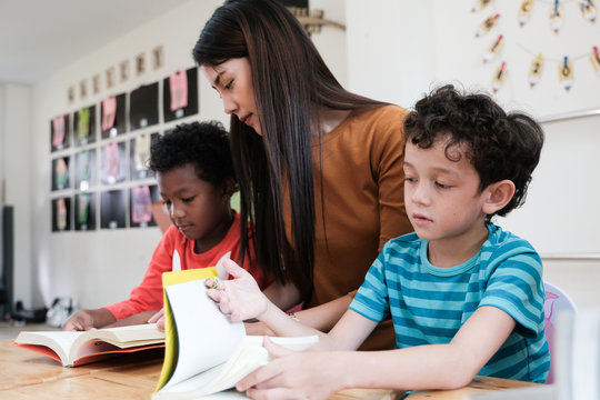 Young Asian Woman Teacher Teaching Kids In Kindergarten Classroom, Preschool Education Concept