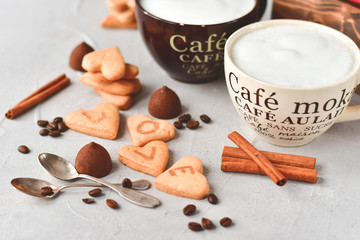 two cups of coffee and cookies in the shape of hearts, on the cookie letters LOVE. the concept of a...