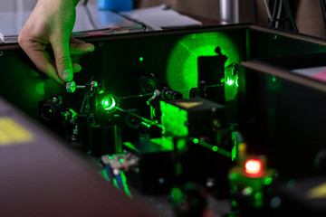 scientist work with laser machine or system b - obrazy, fototapety, plakaty