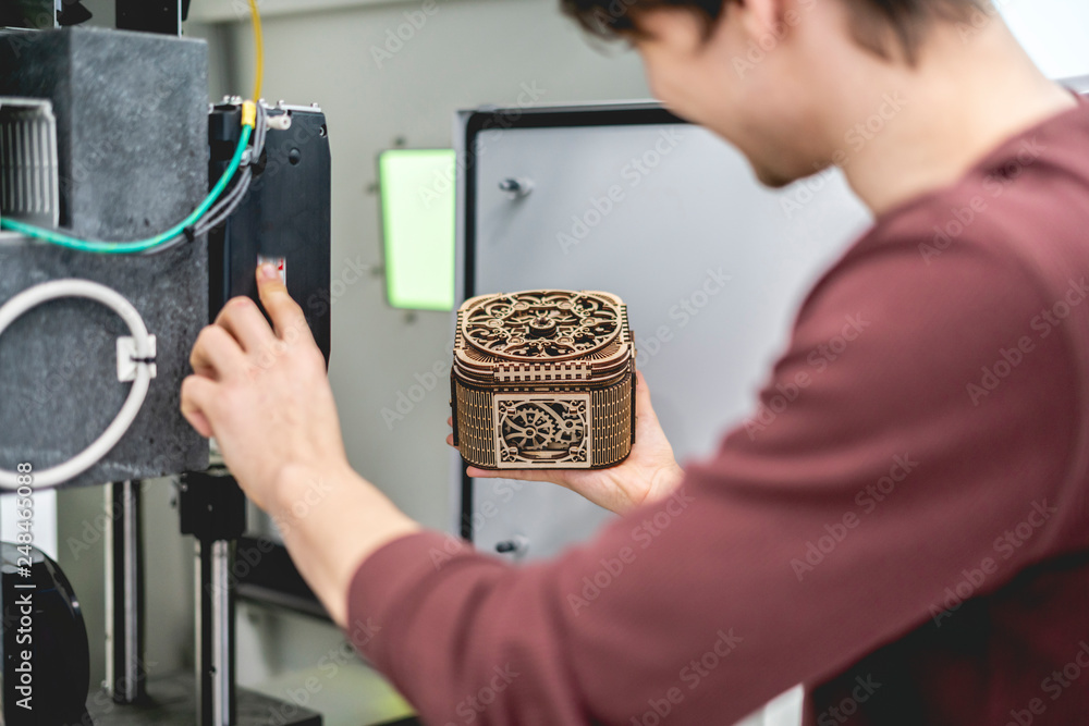 Wall mural male worker carve wood with laser system b