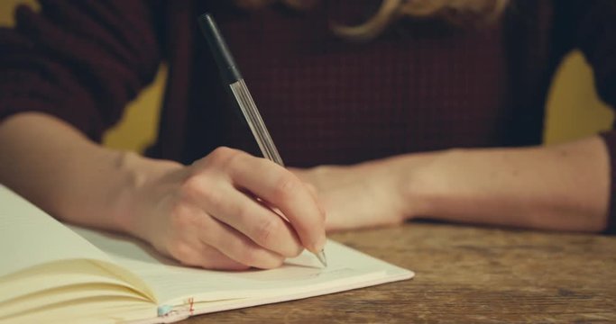 Young woman writing at a desk