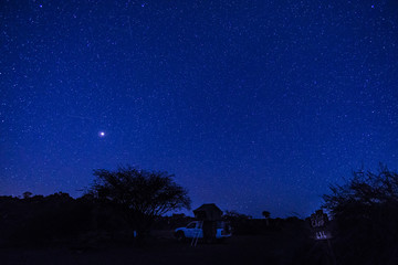 4x4 car with roof tent under a stairy night in Sesriem campsite, Namibia. Africa.