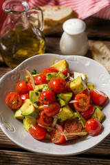Fresh vegetable salad with cherry tomatoes, avocado and shallots