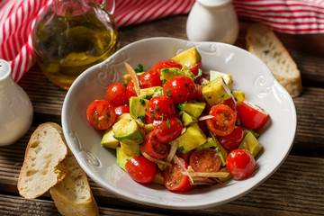 Fresh vegetable salad with cherry tomatoes, avocado and shallots