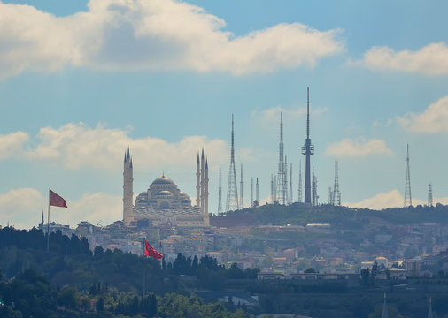 View of the Sultanahmet mosque and communication towers on the shores of Istanbul on the blue sky background.