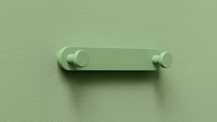 Fancy green metal hanger on colorful wall in studio