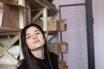 young pretty girl, student, hipster, doing a startup, working in an office or library, browsing dusty shelves with cardboard boxes in typography