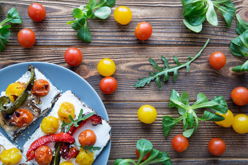 Delicious vegetarian brunch with vegetables on brown rustic background.
