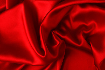Red silk or satin luxury fabric texture can use as abstract background. Top view