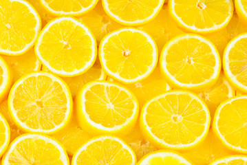 A slices of fresh juicy yellow lemons.  Texture background, pattern.