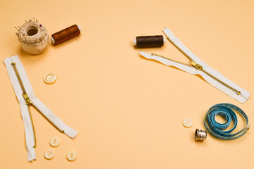 Threads, buttons, red fabric, measuring tape. Copy space.