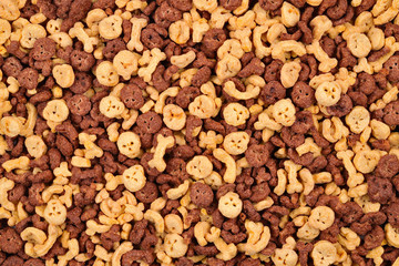  Chocolate flakes in the form of skulls and bones background. Top view.