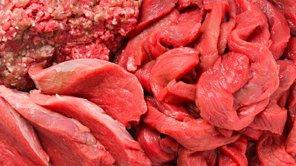 Different types of raw veal background. Slices, minced meat, beef stroganoff.
