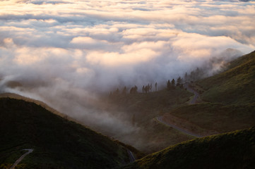 road in the mountains over the clouds