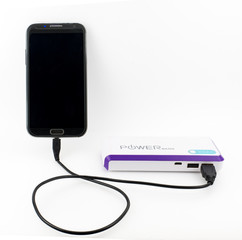 Phone with power bank Smartphone charging with power bank on white background