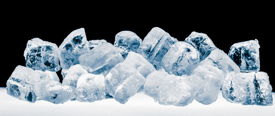 Pieces of blue crushed ice cubes on black background.