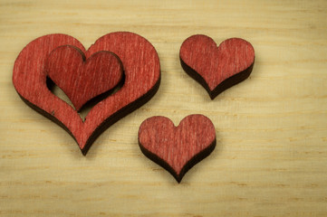 Fototapeta premium Laser cut wooden heart shape on light wood surface