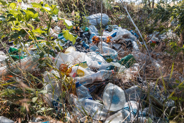 Pile of garage on green grass in the nature environment problems. Nature protection.