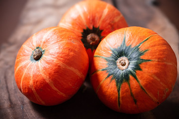 Orange pumpkins on wooden background