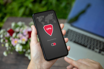 female hand holding phone with app vpn private network