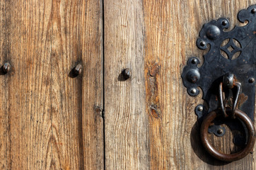 Fototapeta premium Iron handle with ring on an antique door close-up