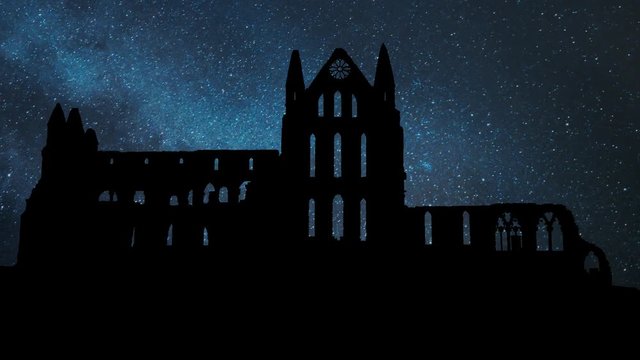 Whitby Abbey Castle by Night with Stars, a Ruined Benedictine monastery sited on Yorkshire, England UK. The Gothic church which Inspired Bram Stoker to write his most Famous Novel Dracula