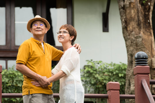 Image of happy romantic Asian senior couple outdoor in park