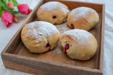 German donuts - krapfen or berliner - filled with jam
