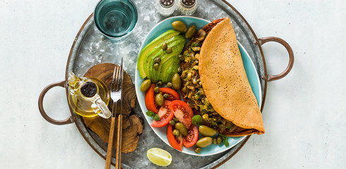 vegan breakfast of gluten-free egg-free chickpea omelet with fried mushrooms and leek. and a salad...