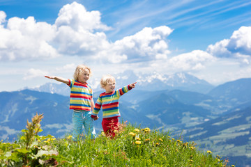 Children hiking in Alps mountains. Kids outdoor.